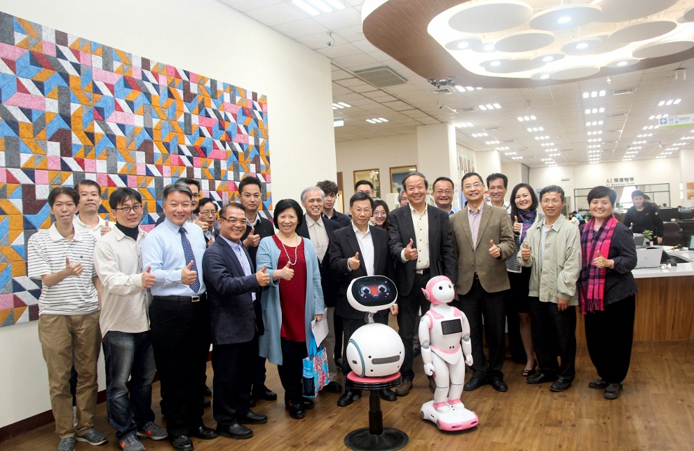 Group photo in front of the AI imagery wall